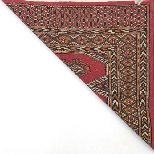 34 - Pink ground geometric patterned rug, 125cm x 80cm