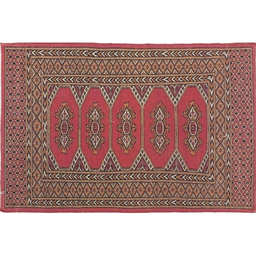 34 - Pink ground geometric patterned rug, 125cm x 80cm