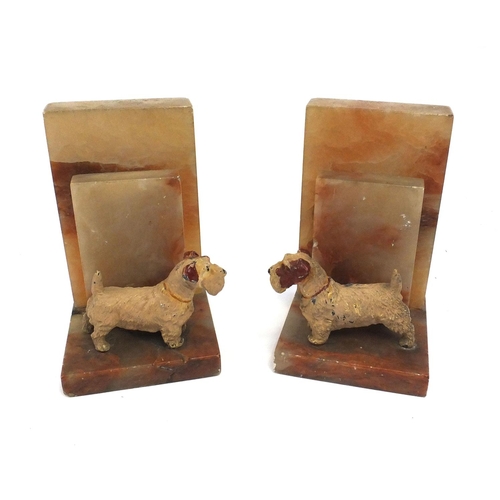 182 - Pair of Art Deco onyx bookends each mounted with a Spelter Terrier dog, 18cm high