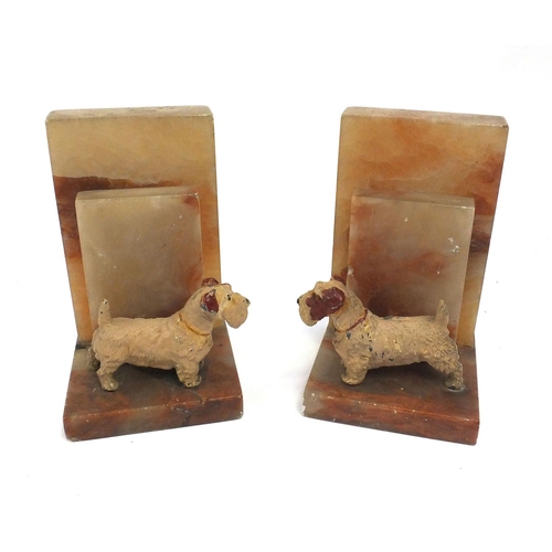 182 - Pair of Art Deco onyx bookends each mounted with a Spelter Terrier dog, 18cm high