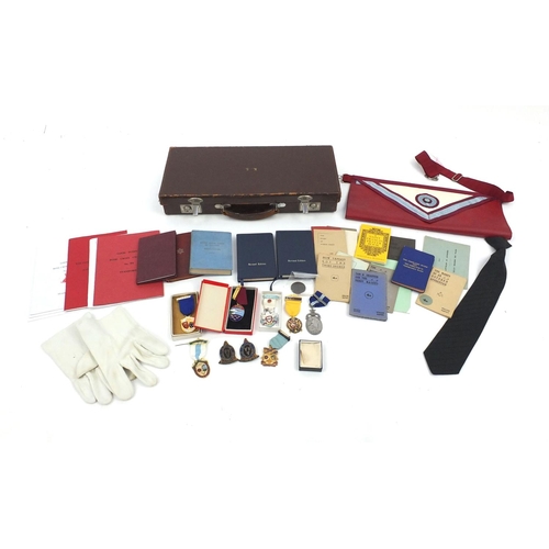 654 - Case of Masonic memorabilia including medals and an apron