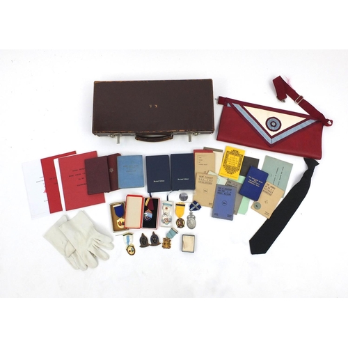 654 - Case of Masonic memorabilia including medals and an apron