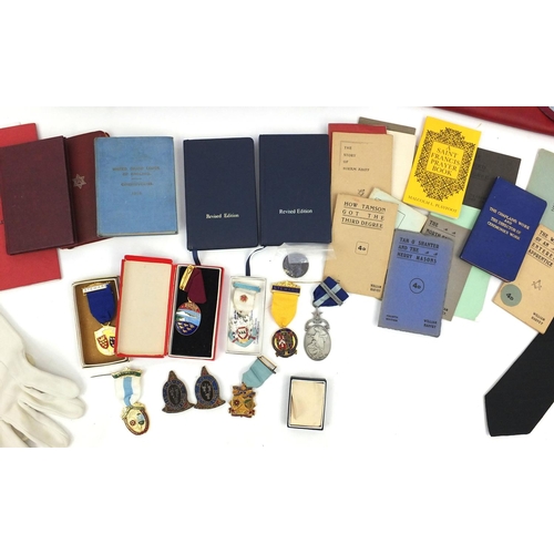 654 - Case of Masonic memorabilia including medals and an apron