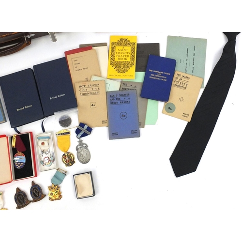 654 - Case of Masonic memorabilia including medals and an apron