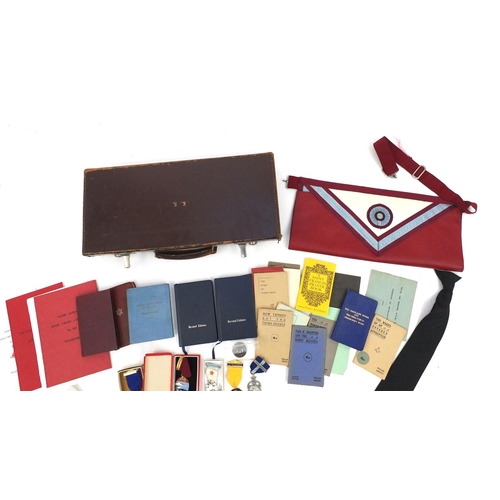 654 - Case of Masonic memorabilia including medals and an apron