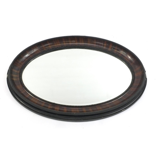 16 - Oval mahogany framed bevelled edge mirror with moulded rope twist decoration, 90cm long