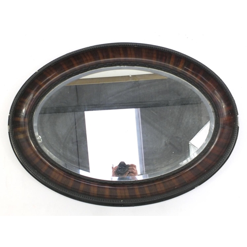 16 - Oval mahogany framed bevelled edge mirror with moulded rope twist decoration, 90cm long