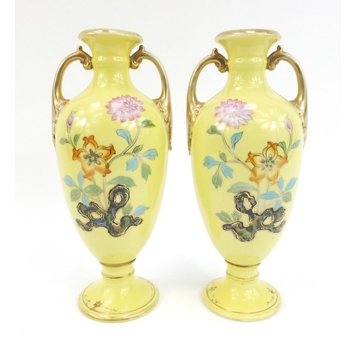 133 - Pair of Noritake twin handled vases decorated with peacocks, 25cm high