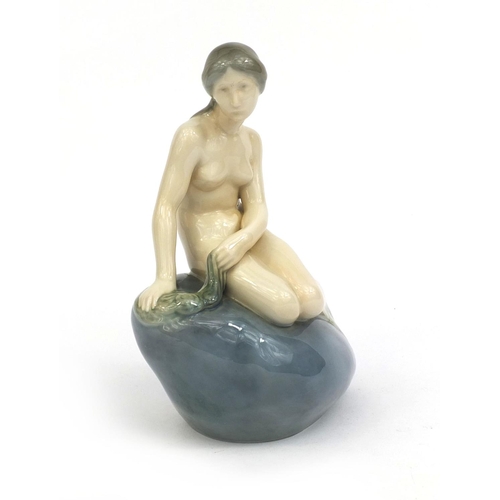 2062 - Royal Copenhagen figurine of a mermaid seated on a rock, factory marks and numbered 4431 to the base... 