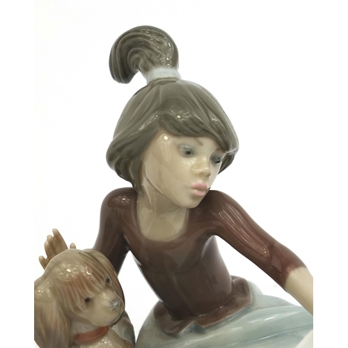 2076 - Two Lladro figures comprising a young girl with a dog and an angel, both with factory marks to the b... 