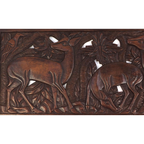 2115 - Large rectangular hardwood panel carved and pierced with deer's amongst trees, 150cm x 49cm