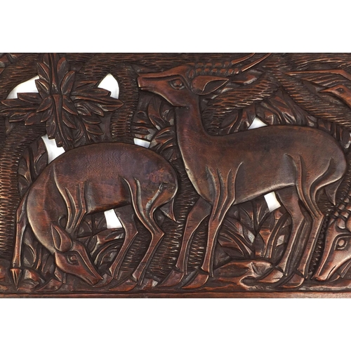 2115 - Large rectangular hardwood panel carved and pierced with deer's amongst trees, 150cm x 49cm