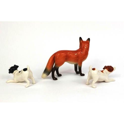 2081 - Three John Beswick animals comprising a fox and to Jack Russell's, each with factory marks to the ba... 