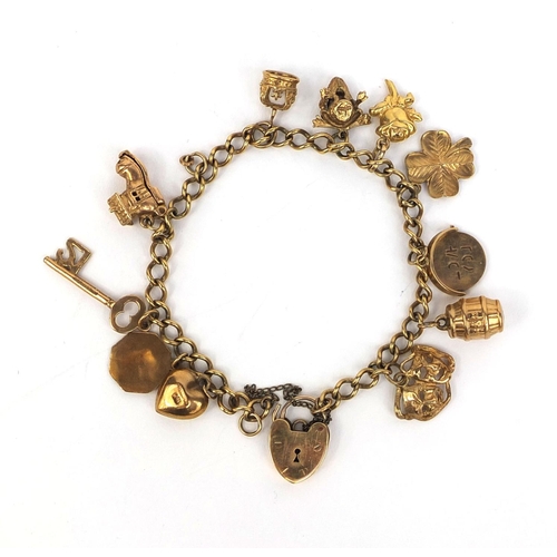 2439 - 9ct gold charm bracelet with a selection of charms including theatre masks, I love you spinner, four... 