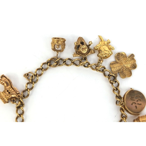 2439 - 9ct gold charm bracelet with a selection of charms including theatre masks, I love you spinner, four... 