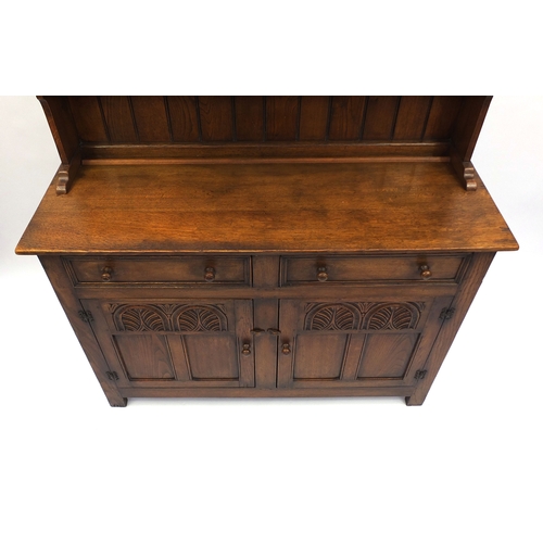2029 - Ipswich oak dresser fitted with two plate racks above two drawers and a pair of carved doors, 180cm ... 