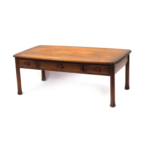 2052 - Ercol elm Windsor / Saville  inspired coffee table fitted with three frieze drawers, 44cm high x 119... 