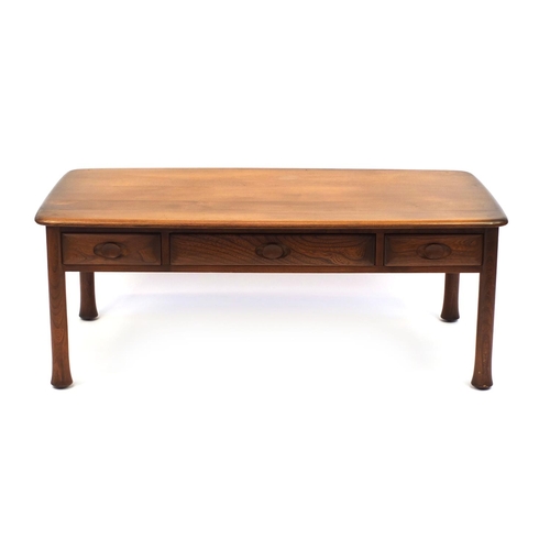 2052 - Ercol elm Windsor / Saville  inspired coffee table fitted with three frieze drawers, 44cm high x 119... 