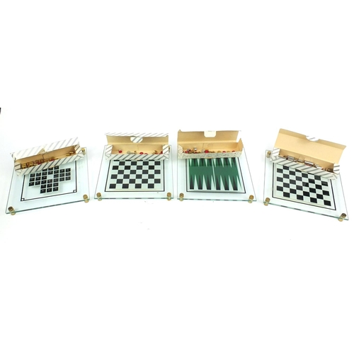 396 - Four boxed glass, brass and stainless steel backgammon and chess sets, designed and manufactured by ... 