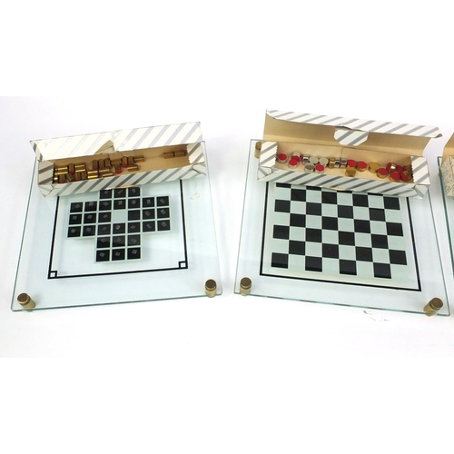 396 - Four boxed glass, brass and stainless steel backgammon and chess sets, designed and manufactured by ... 