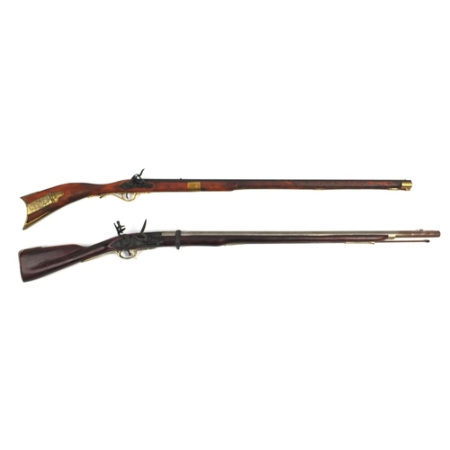 649 - Two decorative flint lock rifles, the larger 148cm long