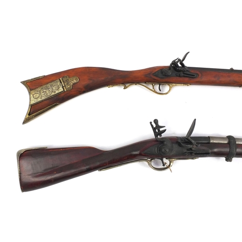 649 - Two decorative flint lock rifles, the larger 148cm long