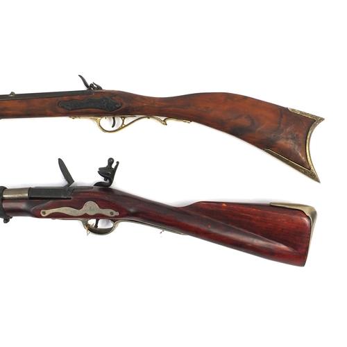 649 - Two decorative flint lock rifles, the larger 148cm long