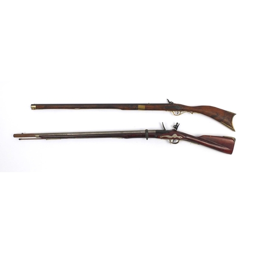 649 - Two decorative flint lock rifles, the larger 148cm long