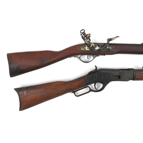 650 - Two decorative rifles including a flint lock, the larger 130cm long