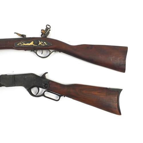 650 - Two decorative rifles including a flint lock, the larger 130cm long