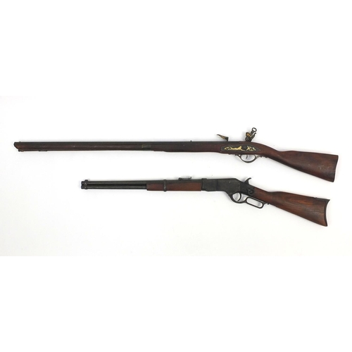 650 - Two decorative rifles including a flint lock, the larger 130cm long