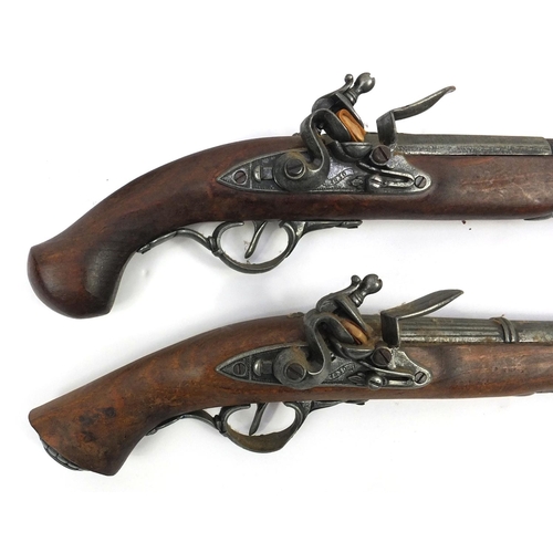 641 - Two decorative flintlock pistols and a revolver, the larger 37cm long