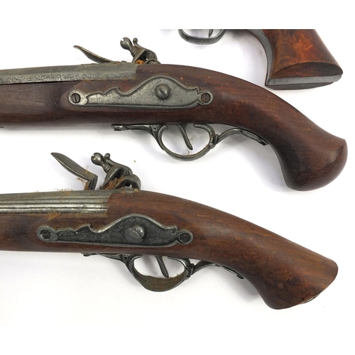 641 - Two decorative flintlock pistols and a revolver, the larger 37cm long