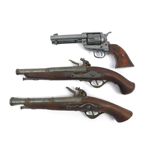 641 - Two decorative flintlock pistols and a revolver, the larger 37cm long