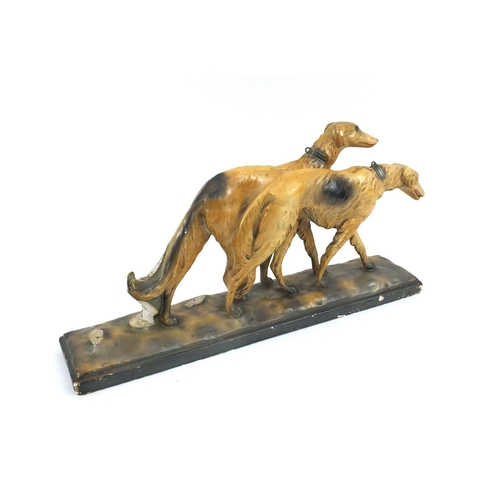 125 - Art Deco plaster group of Afghan hounds, 54cm long