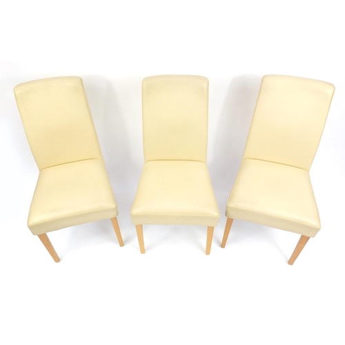 107 - Set of three cream leatherette dining chairs