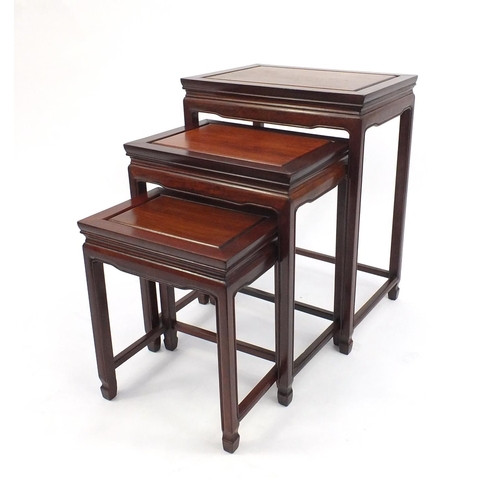 11 - Nest of three Oriental hardwood occasional tables, the largest 66cm high x 51cm wide x 35cm deep