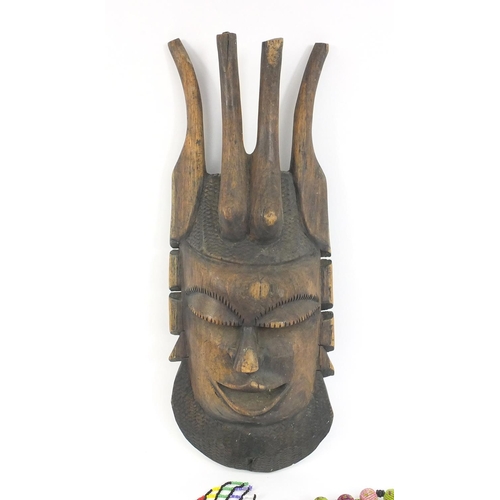 399 - African carved wooden wall mask and a selection of beadwork jewellery