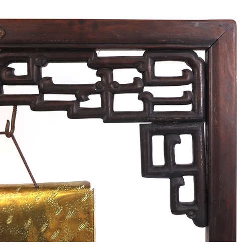 2054 - Chinese carved hardwood dinner gong, with Townshend & Co brass gong, the hardwood frame with stylise... 