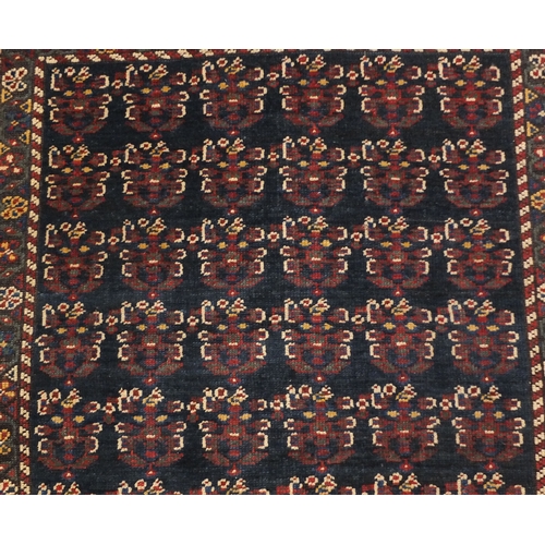 2055 - Rectangular Caucasian carpet runner, the central field having an all over grotesque faces design wit... 