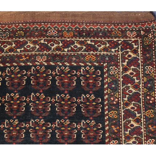 2055 - Rectangular Caucasian carpet runner, the central field having an all over grotesque faces design wit... 