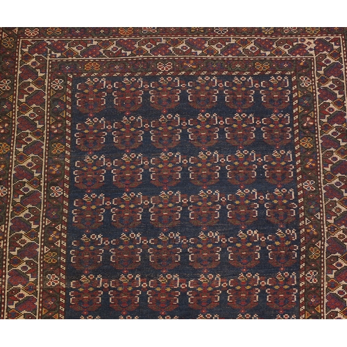 2055 - Rectangular Caucasian carpet runner, the central field having an all over grotesque faces design wit... 