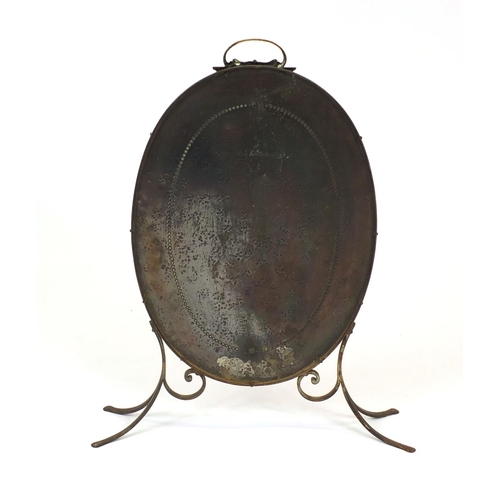 74 - Copper and brass fire screen with brass handle and feet, 76cm high