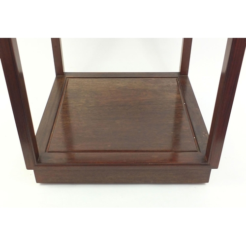 57 - Oriental hardwood occasional table with under tier and castors, 70cm high x 56cm square