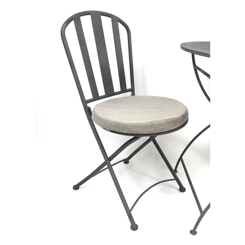 62 - Circular folding metal garden table and two chairs with cushion seats, 75cm high x 70cm in diameter