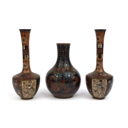 561 - Three Oriental cloisonné vases comprising a pair of vases with hexagonal bodies, decorated with pane... 