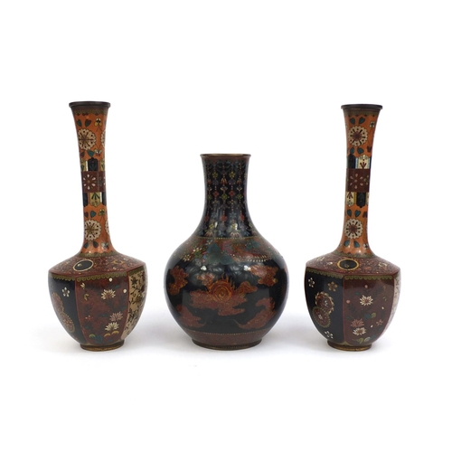 561 - Three Oriental cloisonné vases comprising a pair of vases with hexagonal bodies, decorated with pane... 