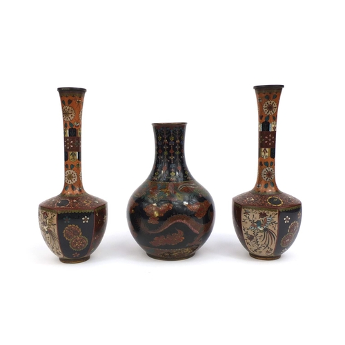 561 - Three Oriental cloisonné vases comprising a pair of vases with hexagonal bodies, decorated with pane... 