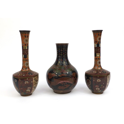 561 - Three Oriental cloisonné vases comprising a pair of vases with hexagonal bodies, decorated with pane... 