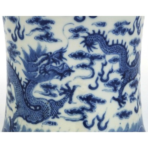 434 - Chinese blue and white porcelain brush pot with waisted body, finely hand painted dragons chasing th... 